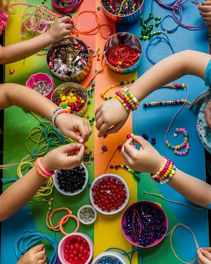 Hands making things at a craft table
