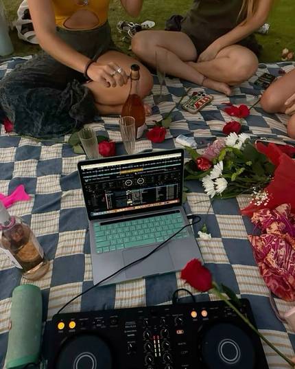 Someone playing music on a picnic blanket